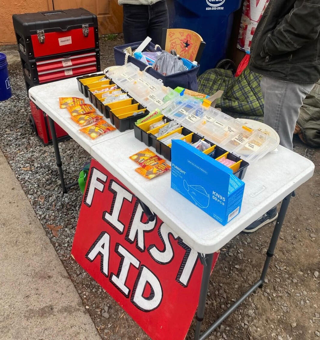 Mutual Aid Wellness Collective the text Mutual Aid Wellness Collective over an anatomical red heart in a black circle